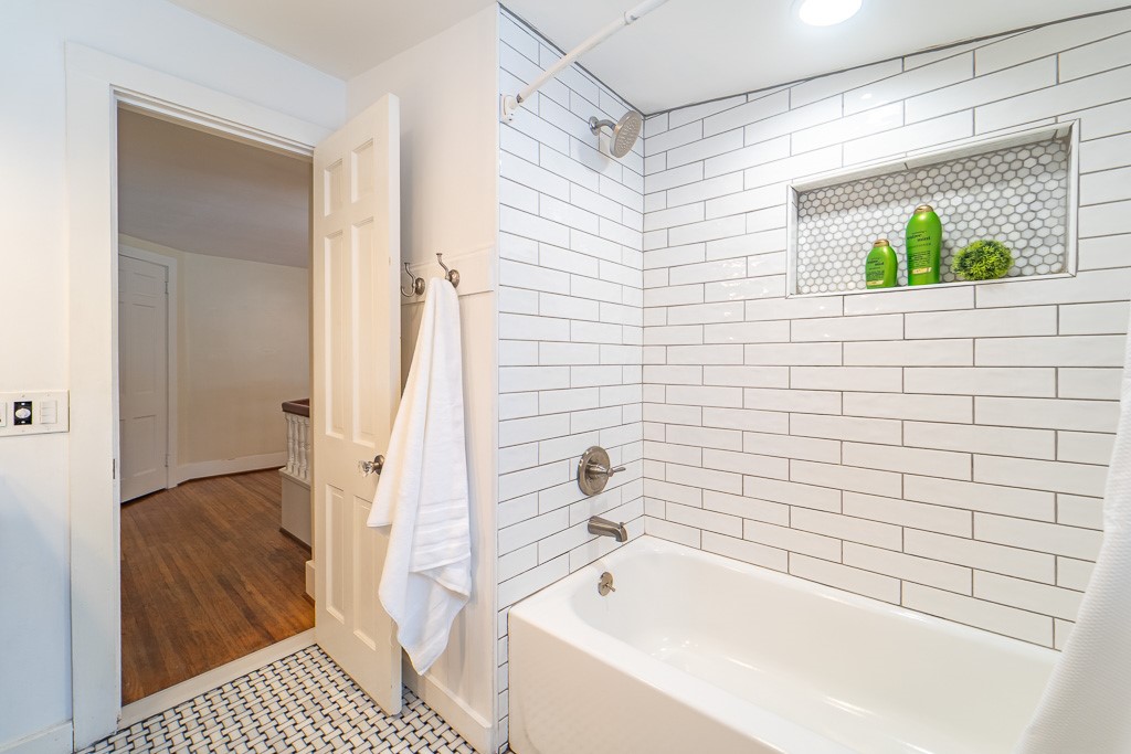 1237 Clover Street Brighton, NY 14610 - Photo 39 of 50 A subway-tiled shower and tub compete this bathroo