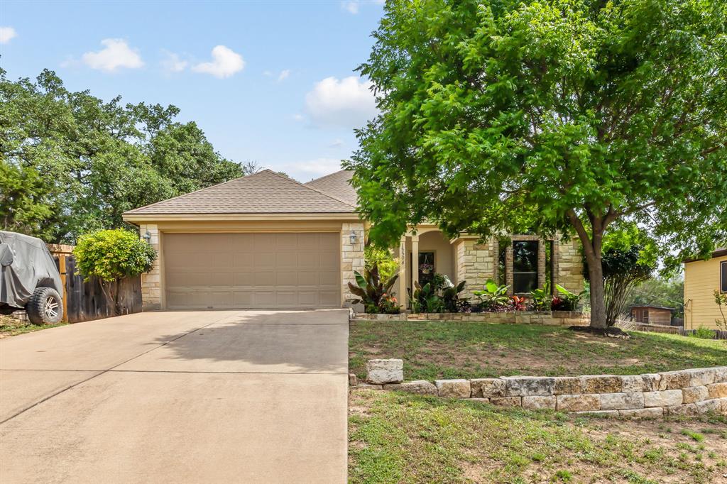 a front view of a house with a yard garage and outdoor seating