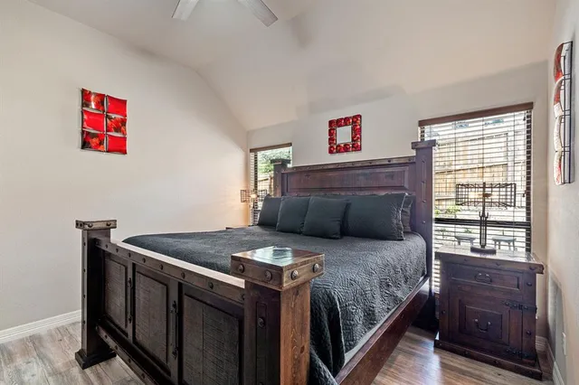 a bedroom with a bed and a dresser next to a window