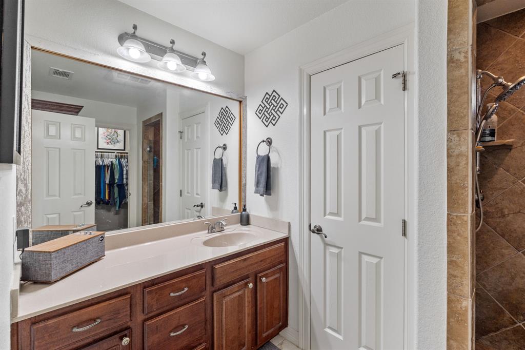 15508 Checotah Drive Austin, TX 78734 - Photo 13 of 23 a bathroom with a double vanity sink and a mirror