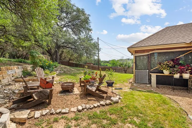 a view of a patio with chairs and plants