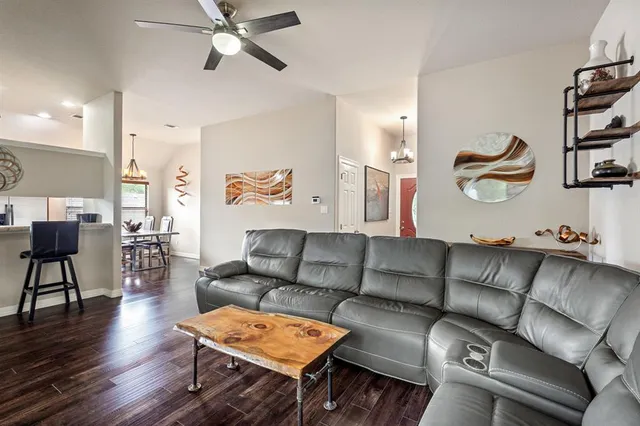 a living room with furniture and wooden floor