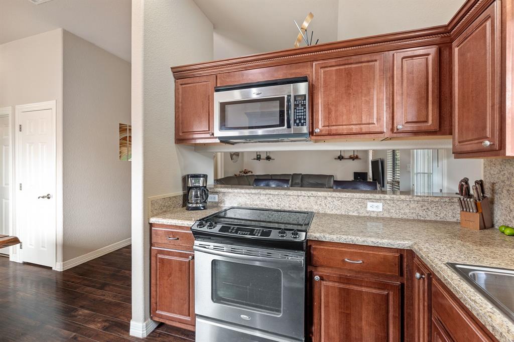 15508 Checotah Drive Austin, TX 78734 - Photo 5 of 23 a kitchen with stainless steel appliances granite countertop a stove microwave and sink