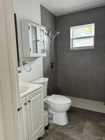 a bathroom with a toilet sink and shower