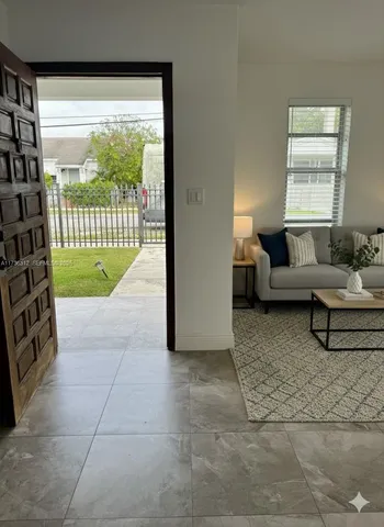 a living room with furniture and a large window