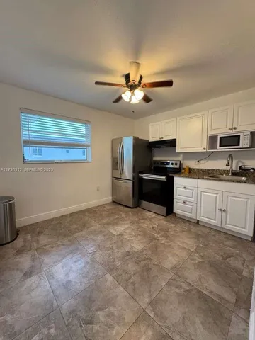 a large kitchen with cabinets and stainless steel appliances