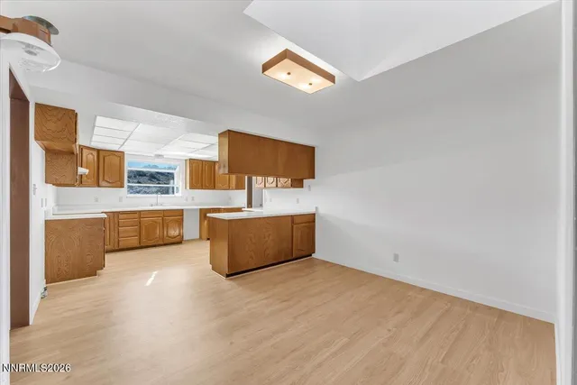 a view of a kitchen with wooden floor and electronic appliances