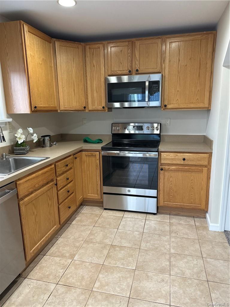100 Dunderberg Road Putnam Valley, NY 10579 - Photo 21 of 29 a kitchen with a stove a sink and a microwave