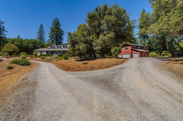 a view of a house with a yard and sitting area