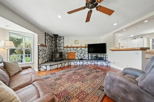 a living room with fireplace furniture and a flat screen tv