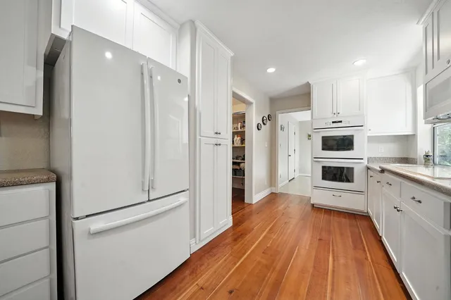 a utility room with cabinets dryer and washer