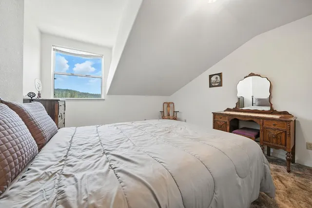 a living room with furniture and a book shelf