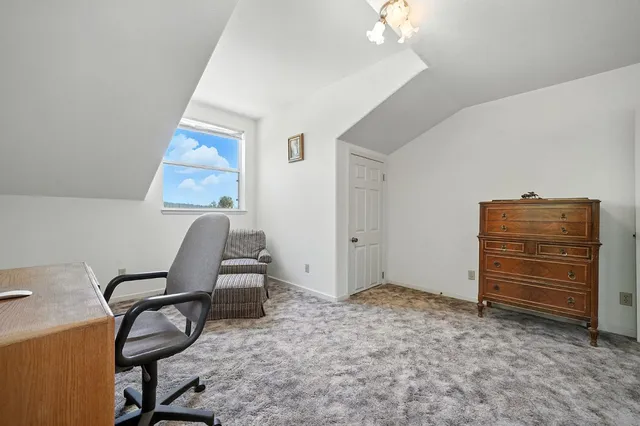 an aerial view of a house with a yard and outdoor seating
