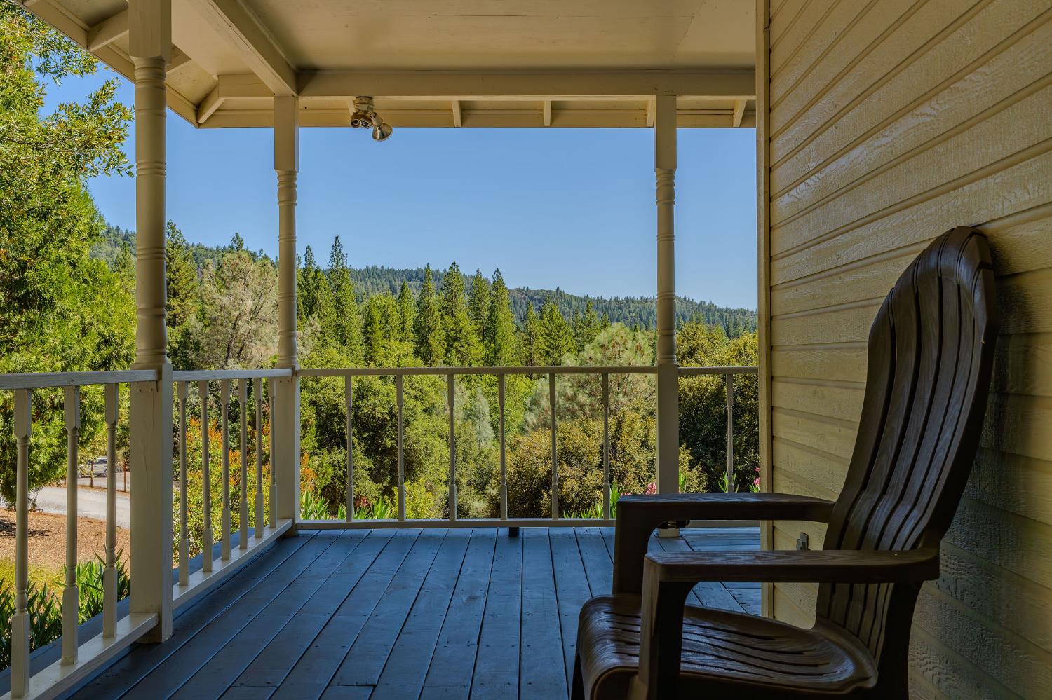 17050 Rams Horn Grade Road Volcano, CA 95689 - Photo 56 of 96 a view of a balcony with chair and wooden floor