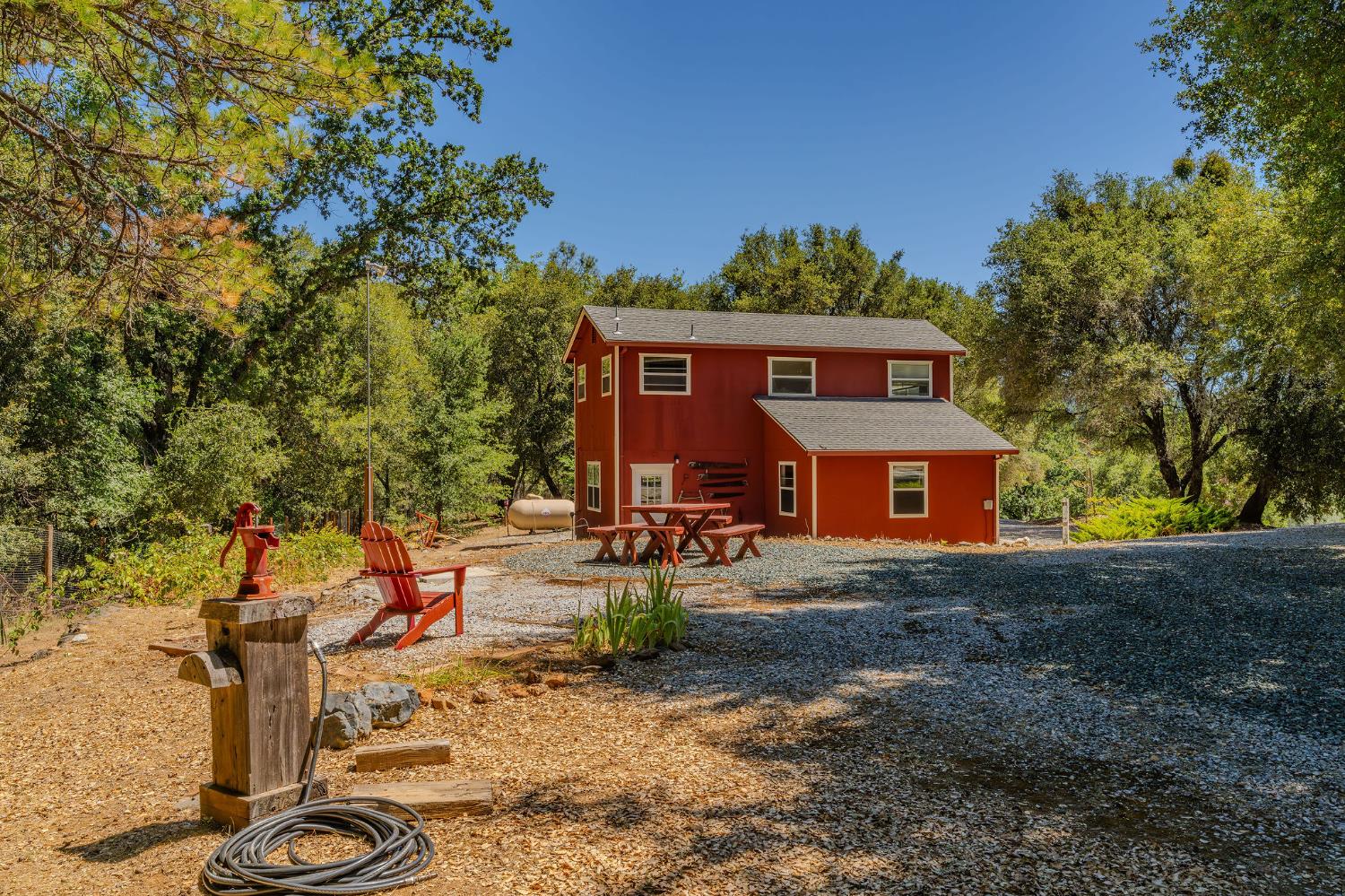 17050 Rams Horn Grade Road Volcano, CA 95689 - Photo 74 of 96 a front view of a house with yard patio and fire pit