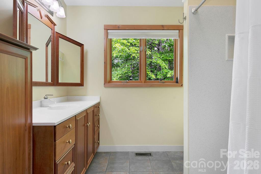 40 Walnut Ridge Road Brevard, NC 28712 - Photo 23 of 47 a view of a bathroom with a sink and a window
