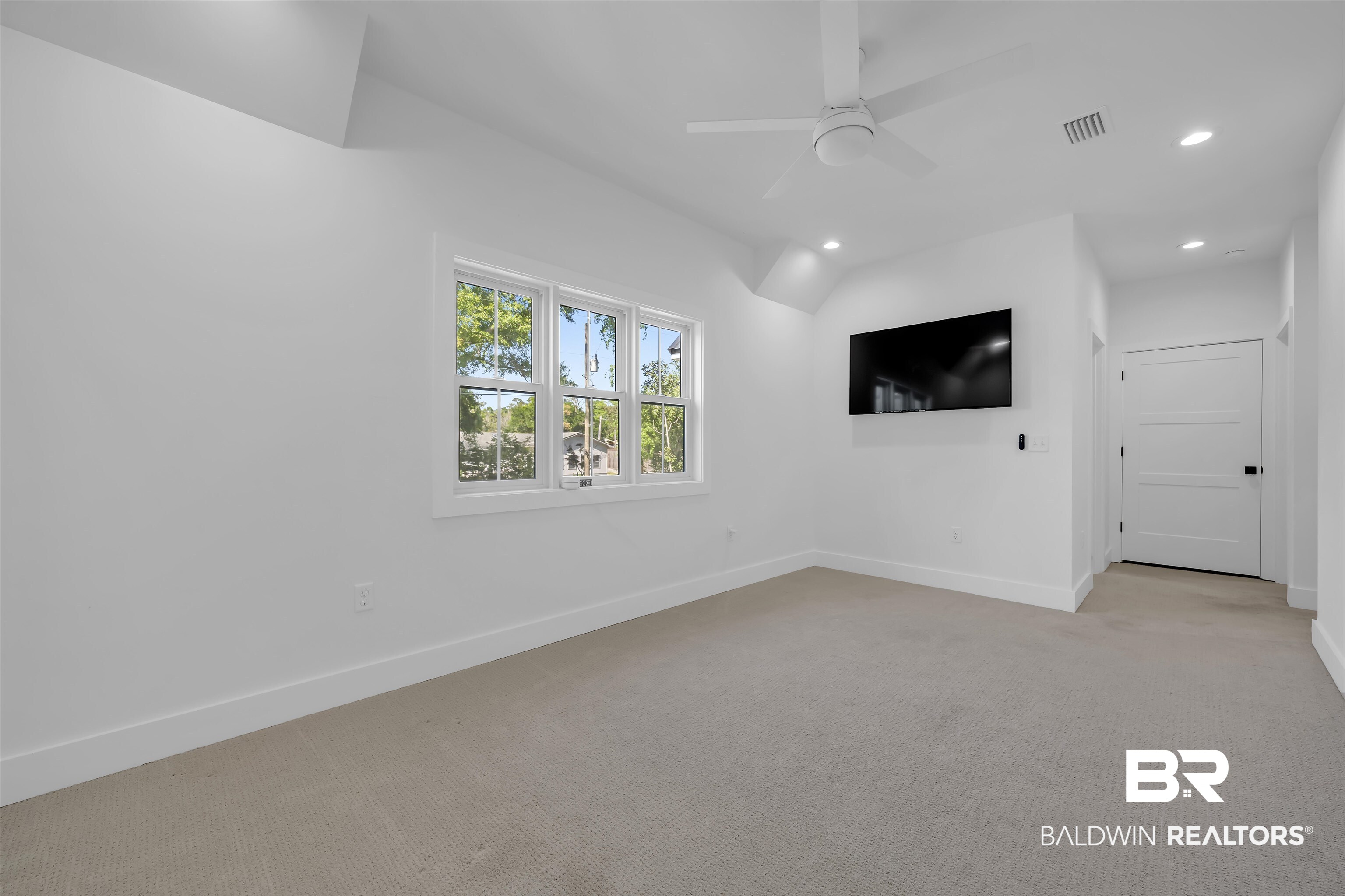 19058 James Road Gulf Shores, AL 36542 - Photo 31 of 49 Empty room featuring light carpet, a ceiling fan, and recessed lighting