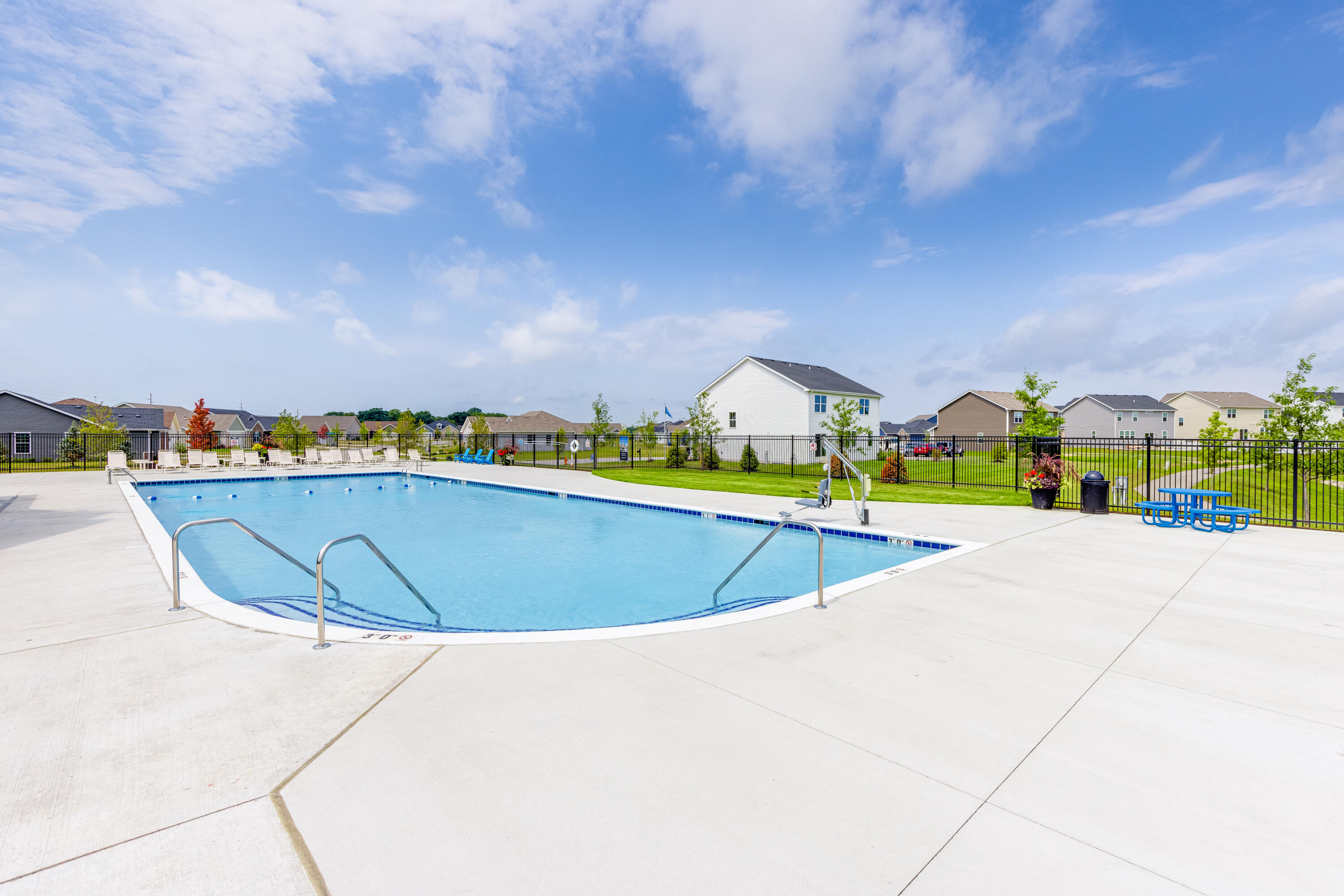 5984 East 112th Place Winfield, IN 46307 - Photo 28 of 41 a view of a swimming pool with an outdoor seating and a residential buildings