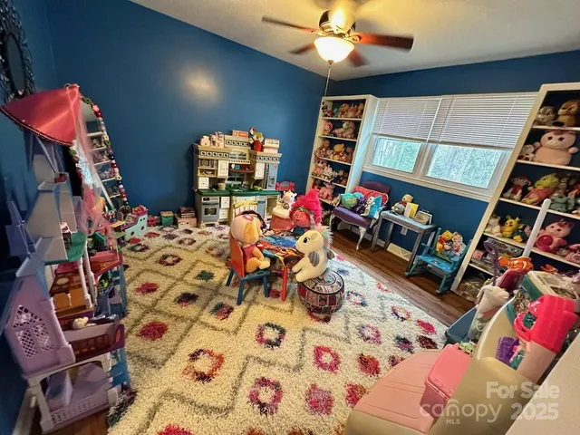 walk in closet with clothes and shoes