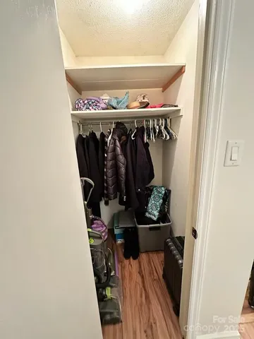 a view of water heater room with wooden floor