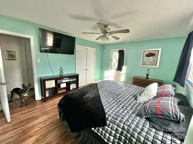 a bedroom with a bed and a mirror on the dresser