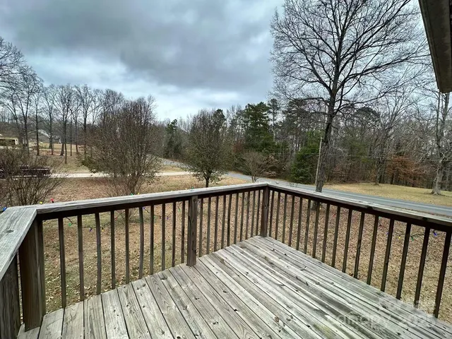 a balcony with wooden floor and fence