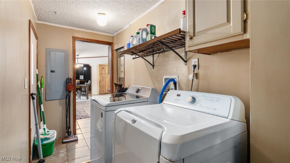 13306 Fairview Road Southeast Newark, OH 43056 - Photo 35 of 48 Laundry area featuring ornamental molding, electric panel, light tile patterned floors, a textured ceiling, and washer and clothes dryer