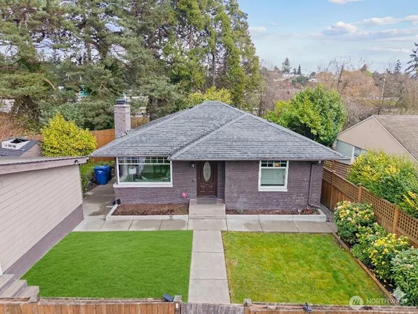 a front view of house with yard and outdoor seating