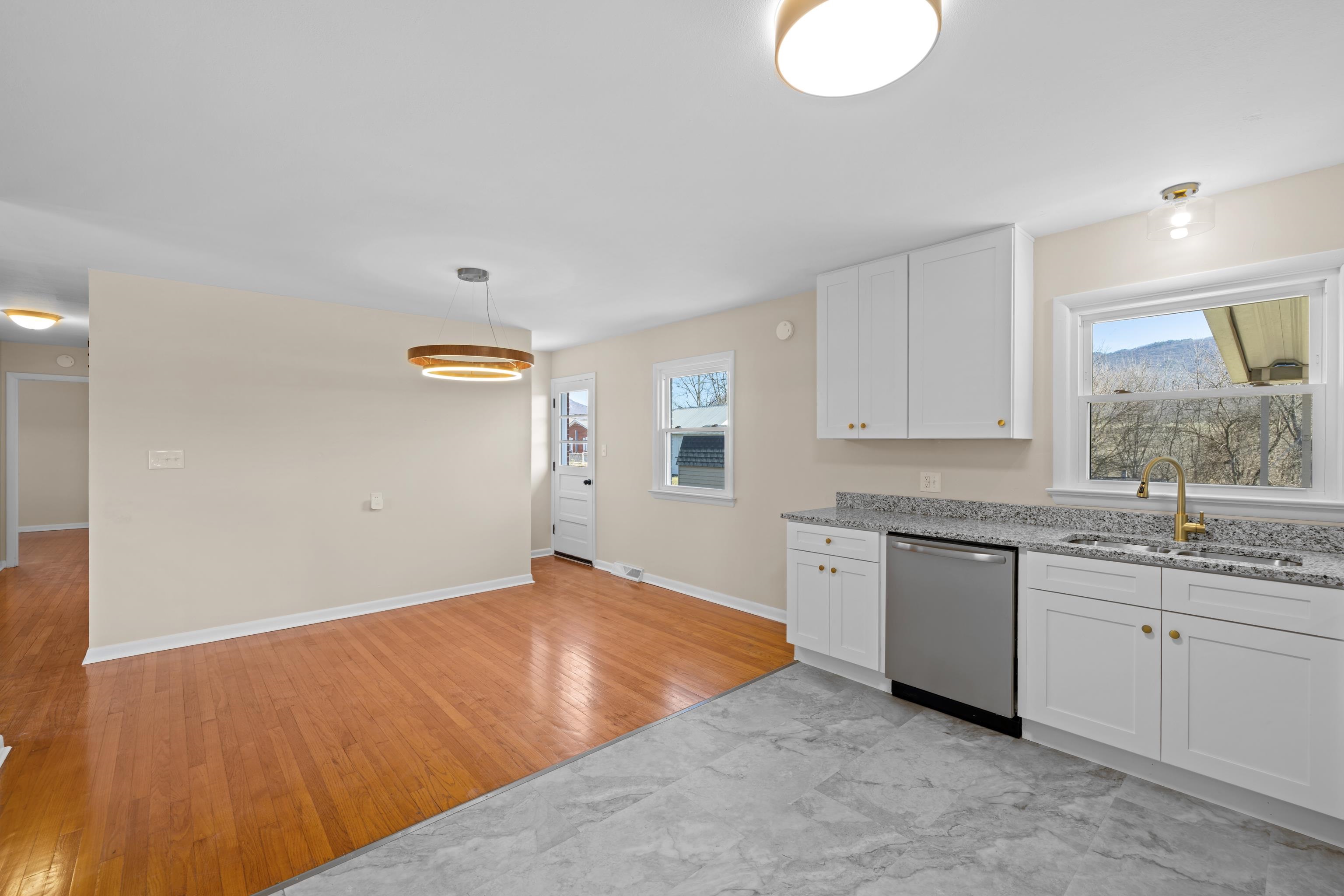 1726 Mountain Valley Road Keezletown, VA 22832 - Photo 15 of 63 a kitchen with granite countertop a sink cabinets and wooden floor