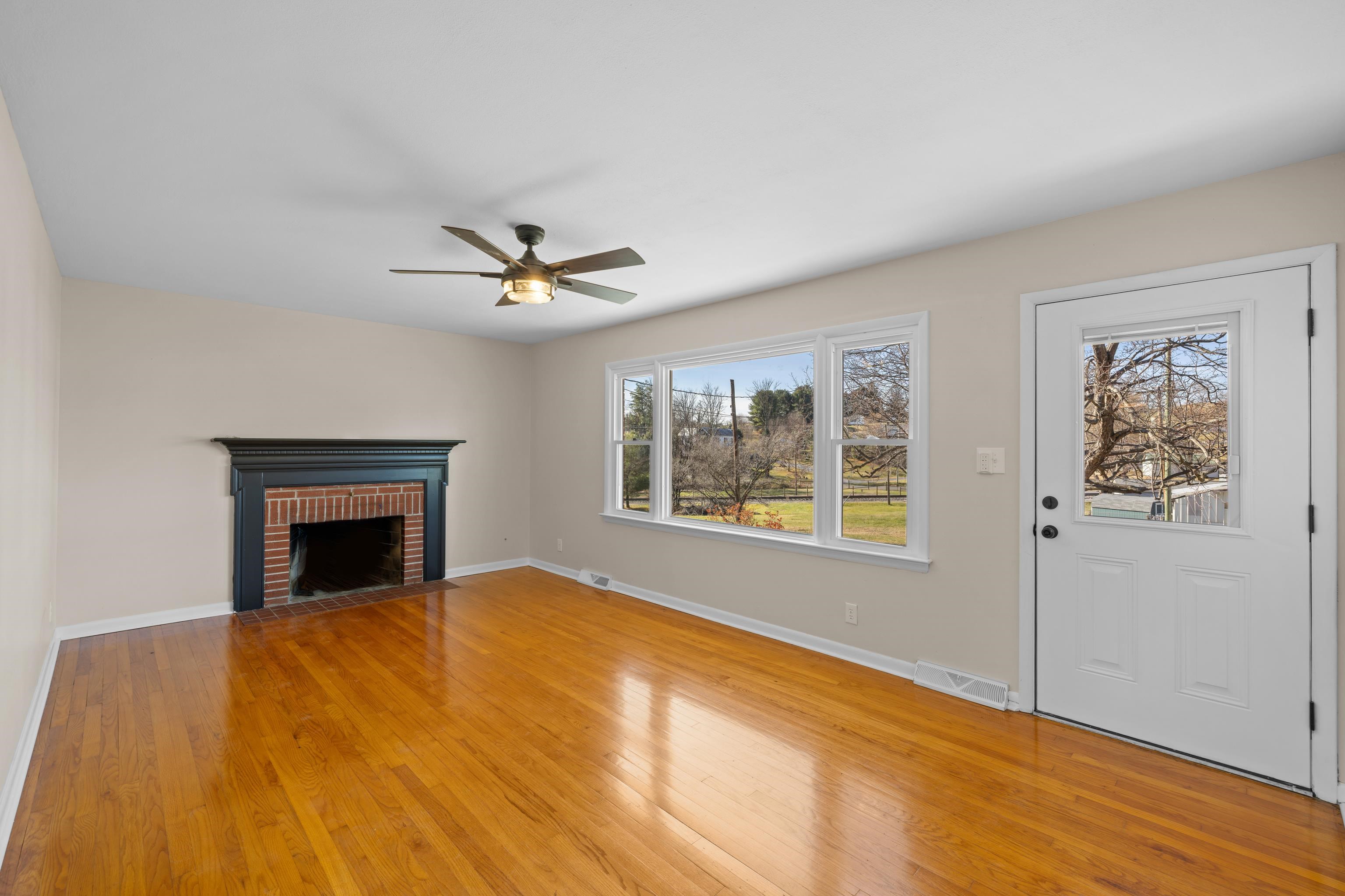 1726 Mountain Valley Road Keezletown, VA 22832 - Photo 16 of 63 a view of an empty room with wooden floor and a window