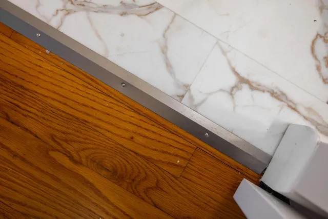 a view of a big room with wooden floor and a ceiling fan