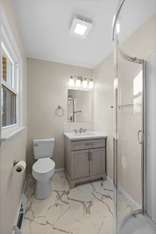 an empty room with wooden floor and ceiling fan