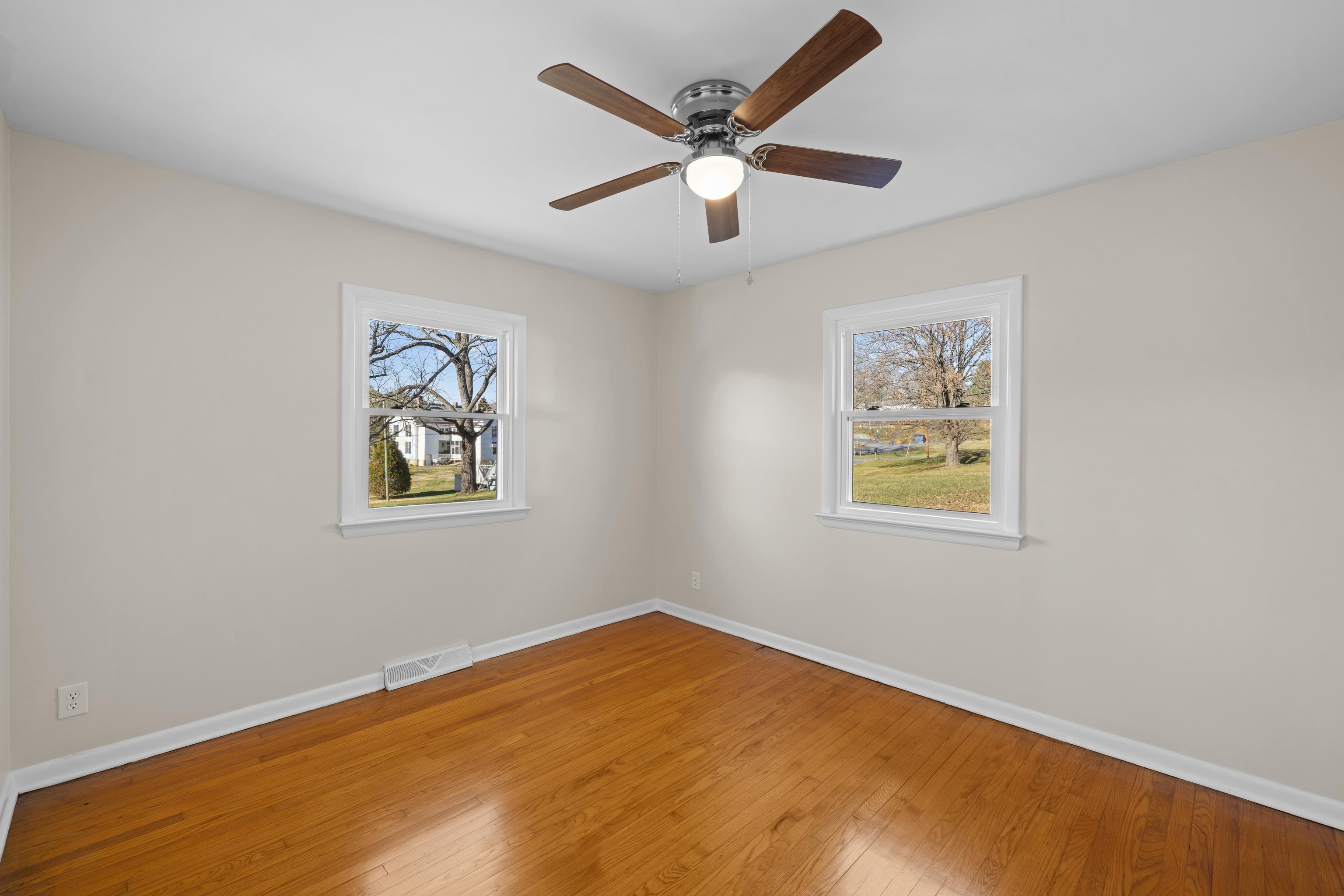 1726 Mountain Valley Road Keezletown, VA 22832 - Photo 28 of 63 a view of a big room with wooden floor and a ceiling fan