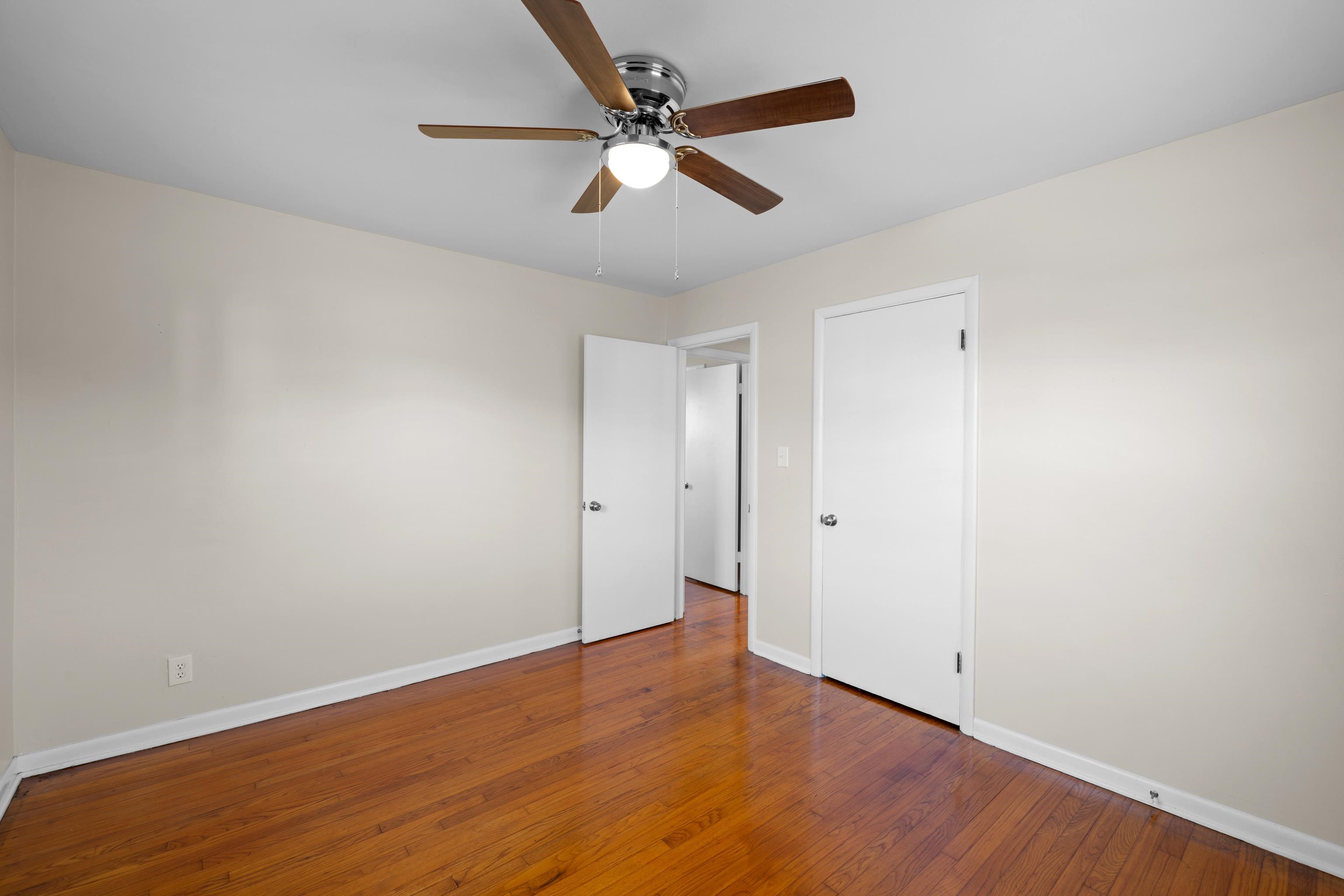 1726 Mountain Valley Road Keezletown, VA 22832 - Photo 29 of 63 an empty room with wooden floor and ceiling fan