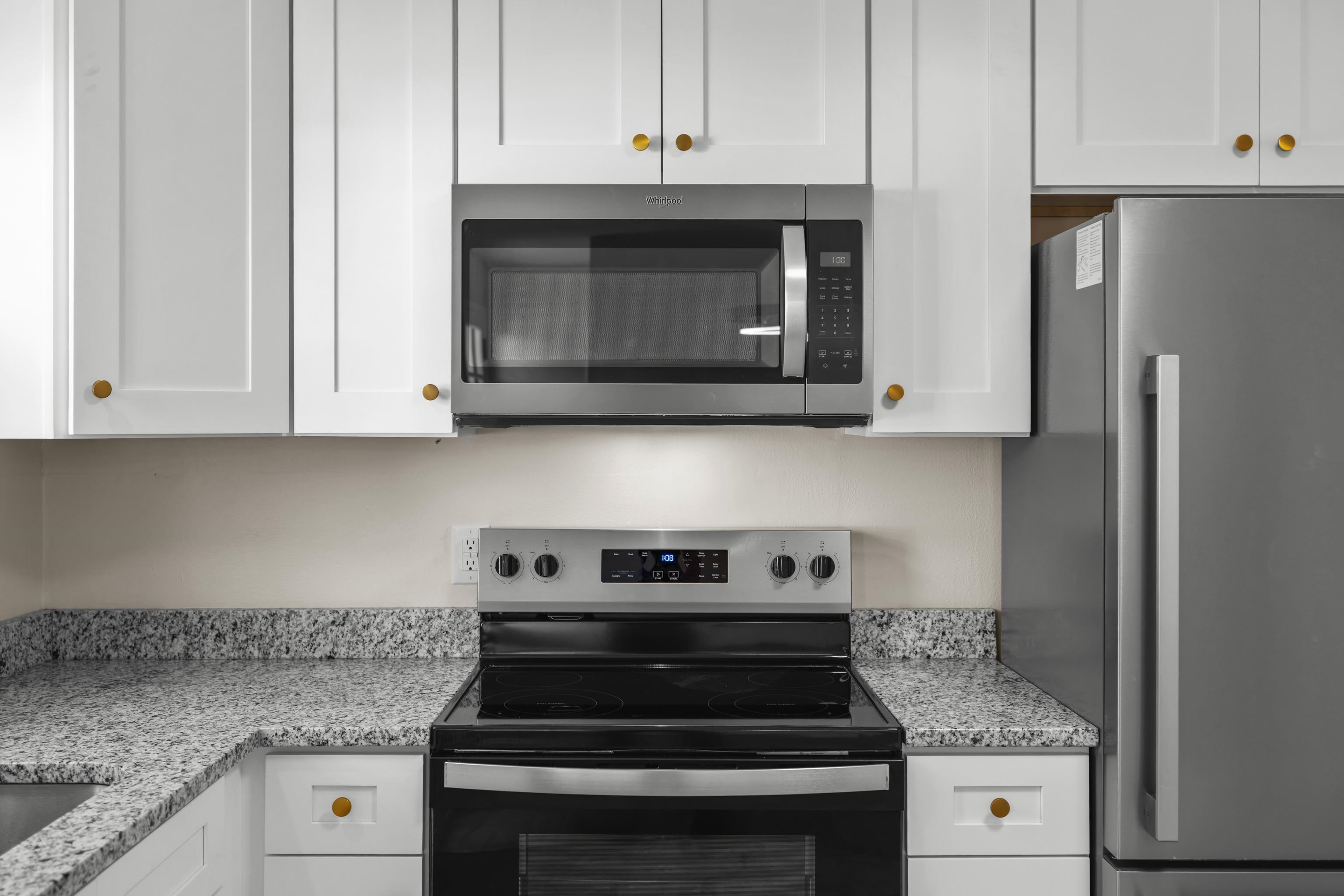 1726 Mountain Valley Road Keezletown, VA 22832 - Photo 10 of 63 a kitchen with stainless steel appliances granite countertop white cabinets and stove