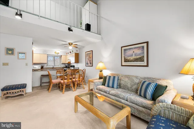 a living room with furniture kitchen view and a table