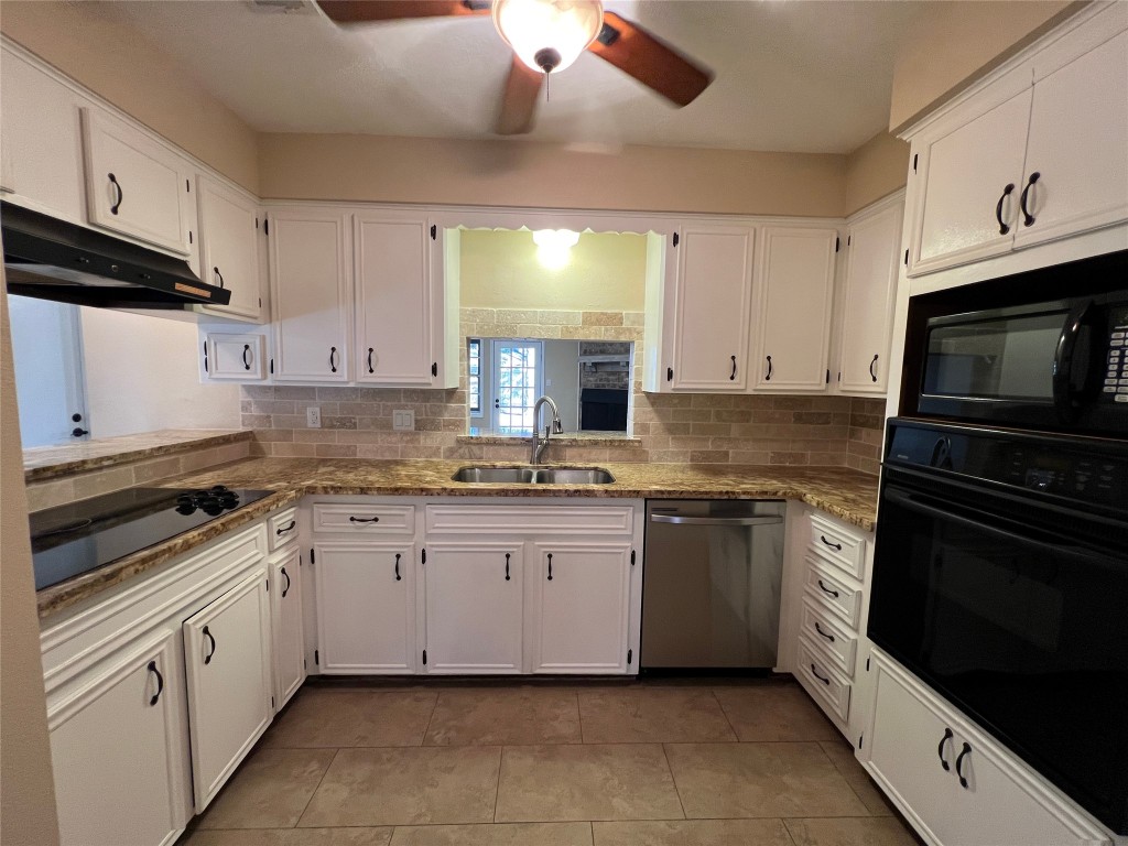25314 Hickory Valley Lane Spring, TX 77373 - Photo 12 of 33 a kitchen with granite countertop white cabinets stainless steel appliances and a sink