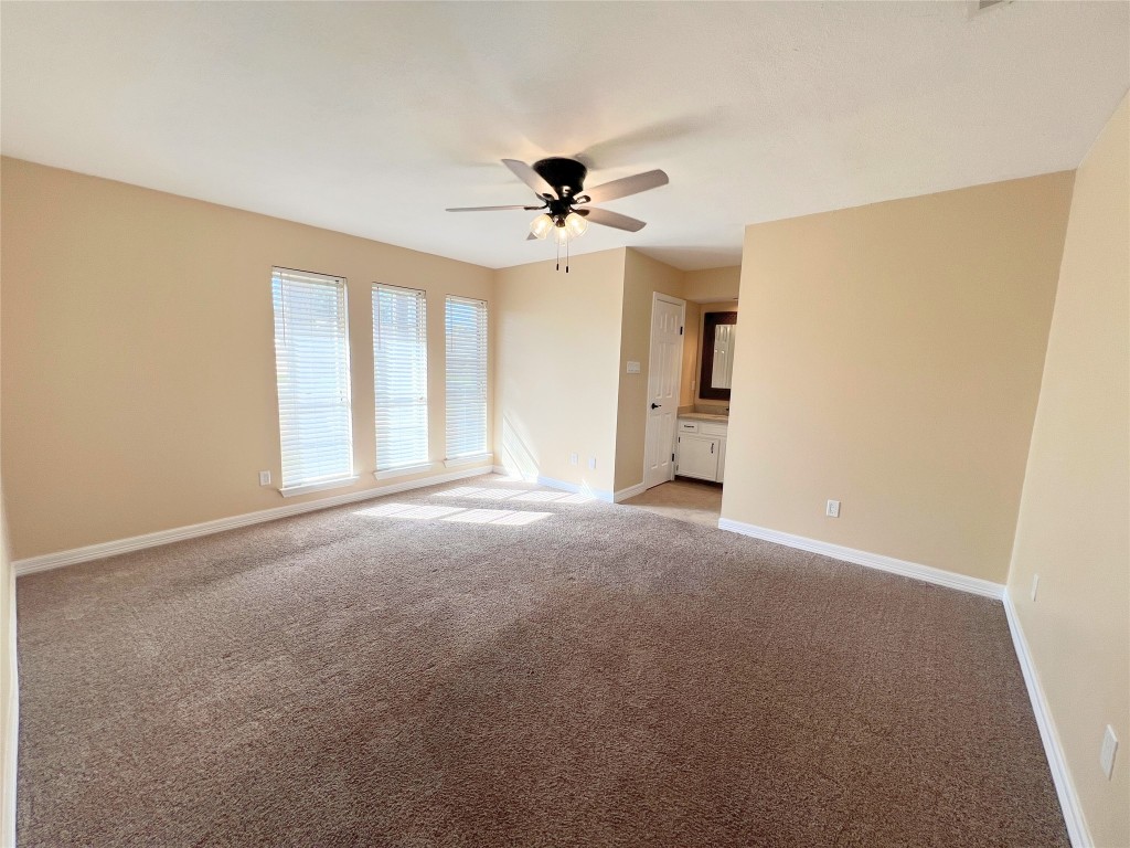 25314 Hickory Valley Lane Spring, TX 77373 - Photo 17 of 33 a view of a big room with windows and chandelier fan