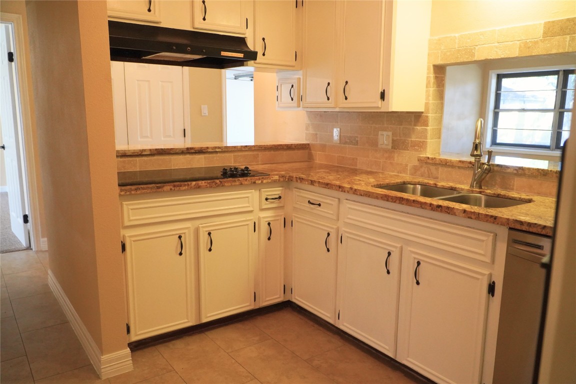 25314 Hickory Valley Lane Spring, TX 77373 - Photo 10 of 33 a kitchen with stainless steel appliances granite countertop a sink and dishwasher with white cabinets