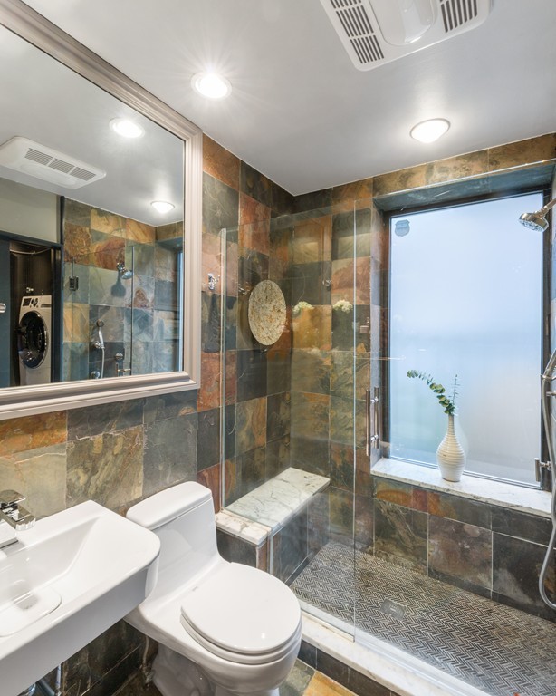 15 East Springfield Street, Unit 2 Boston, MA 02118 - Photo 13 of 17 a bathroom with a sink a toilet a mirror and a glass door shower