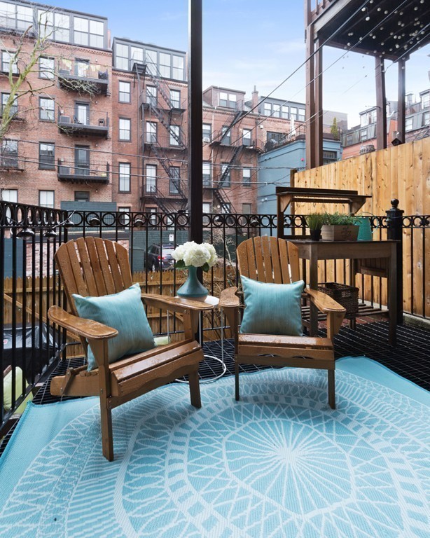 15 East Springfield Street, Unit 2 Boston, MA 02118 - Photo 15 of 17 a roof deck with a couch and chairs