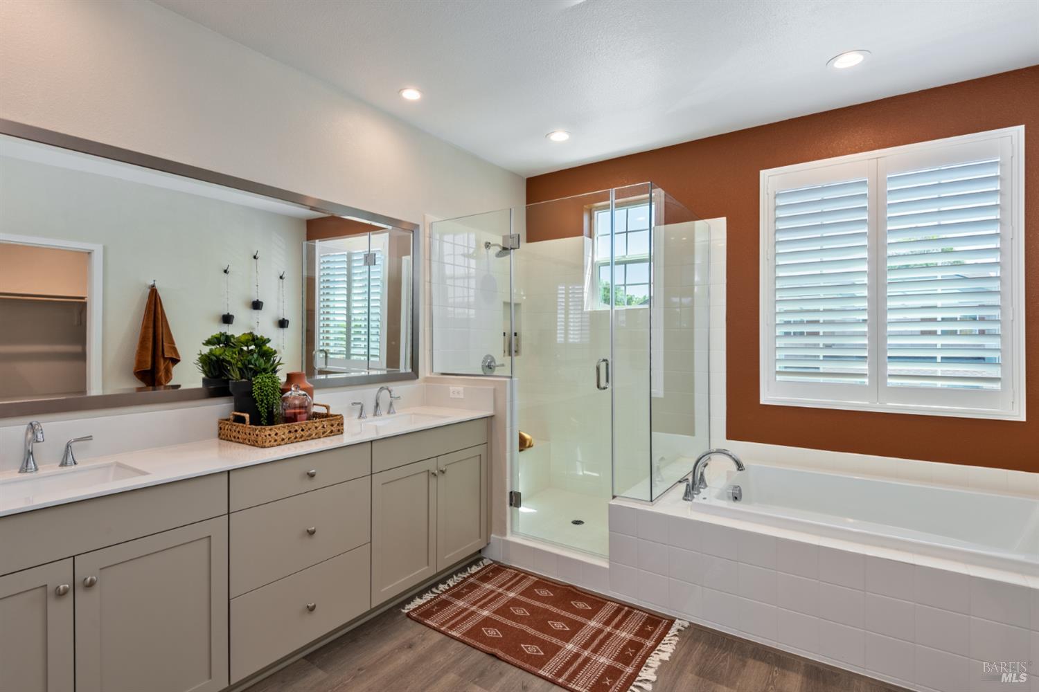 2534 Courtney Avenue Santa Rosa, CA 95403 - Photo 4 of 17 a bathroom with a double vanity sink large mirror and a bathtub