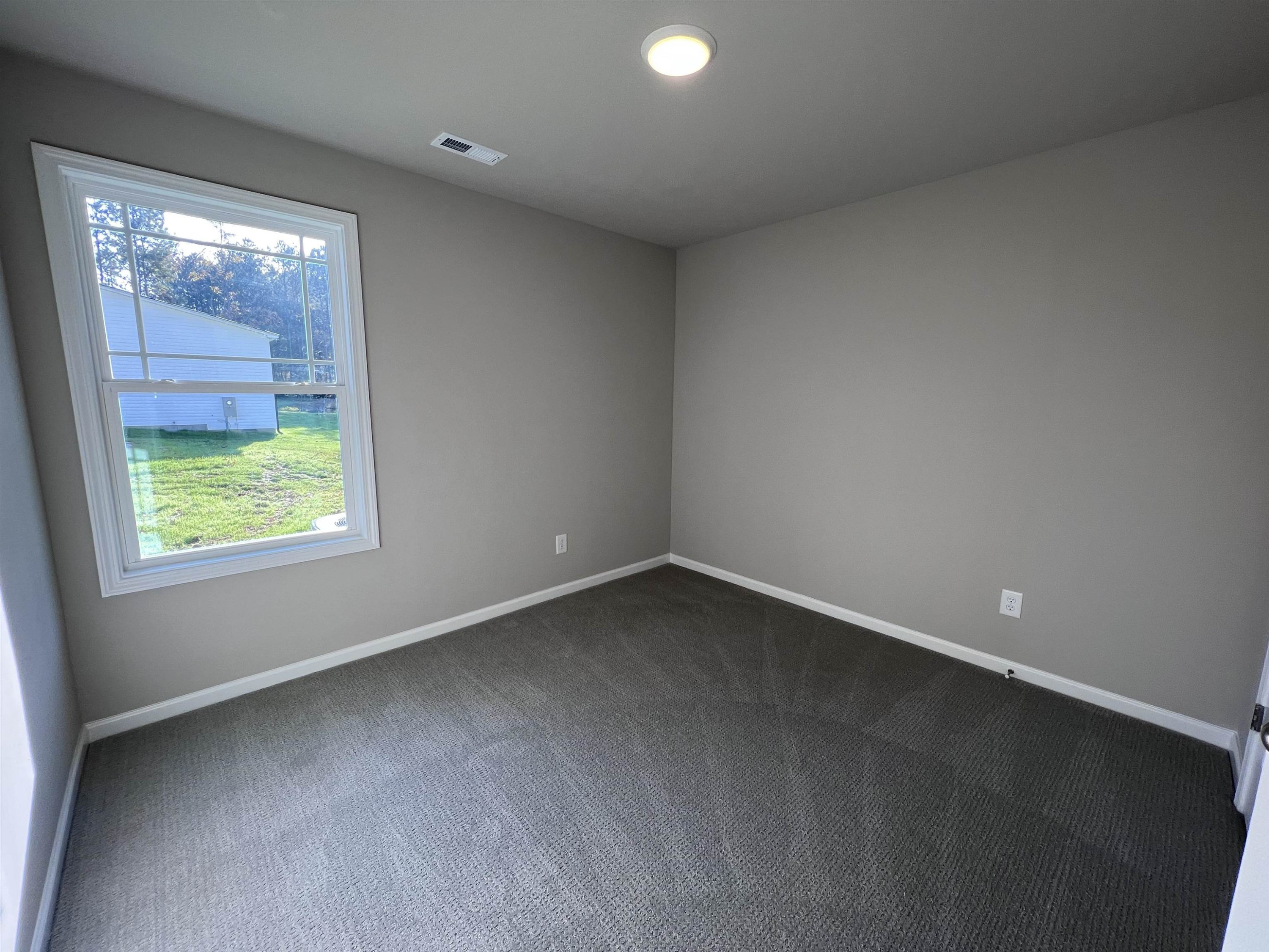 464 Roberts Road Willow Spring, NC 27592 - Photo 13 of 16 an empty room with a window