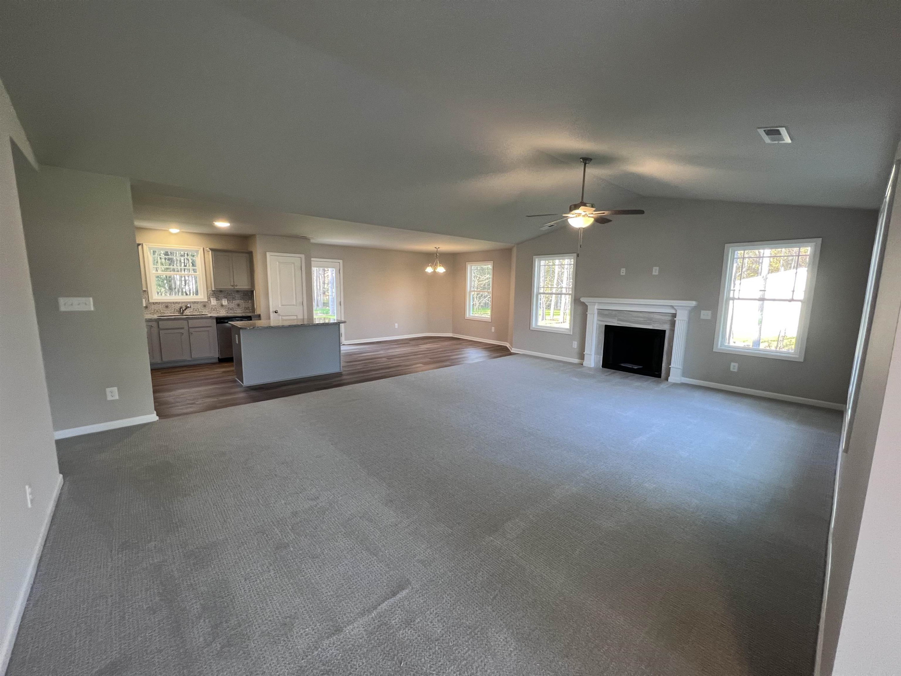 464 Roberts Road Willow Spring, NC 27592 - Photo 5 of 16 a view of empty room with a kitchen and fireplace