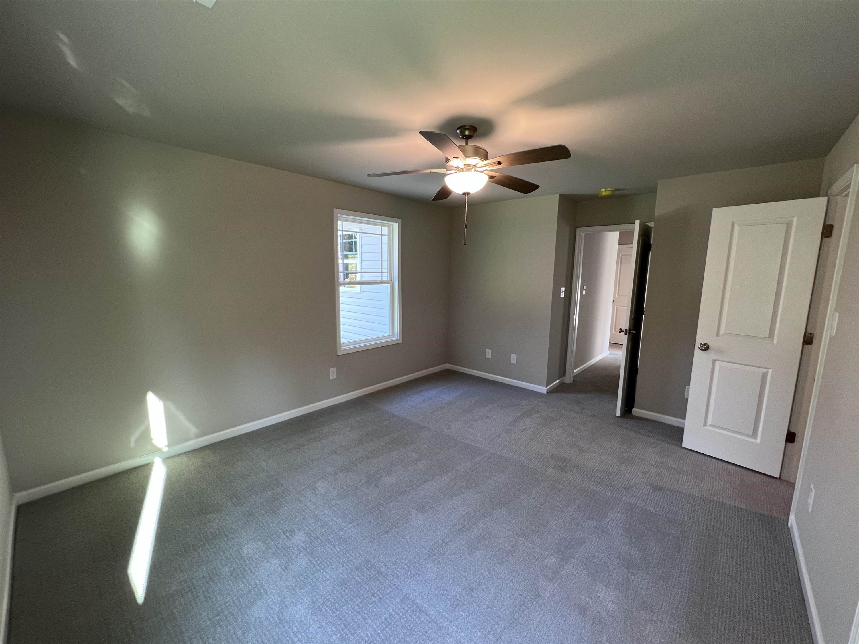 464 Roberts Road Willow Spring, NC 27592 - Photo 8 of 16 wooden floor in an empty room with a window