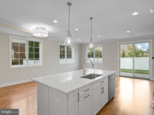 a kitchen with a sink center island and windows