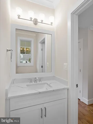 a bathroom with a sink and two mirror
