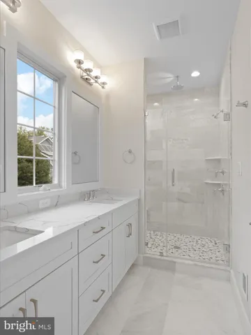 a bathroom with a shower sink and mirror