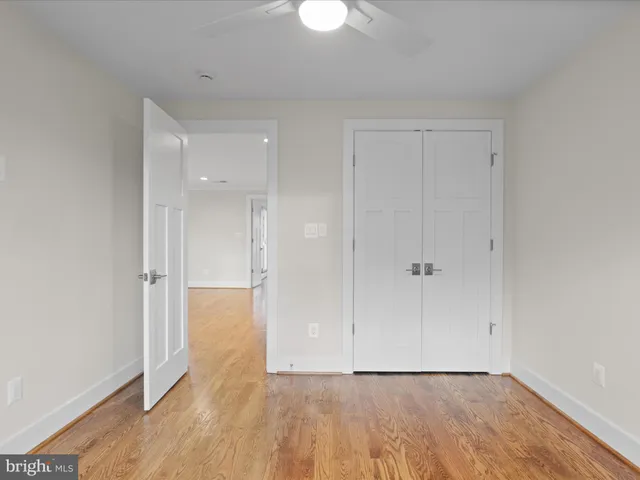 a view of an empty room and wooden floor