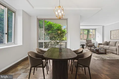 a white bench sitting in a backyard of a house